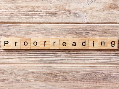 proofreading word written on wood block. proofreading text on table, concept