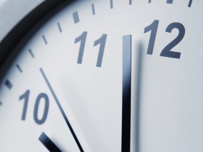 Closeup of hands on clock face